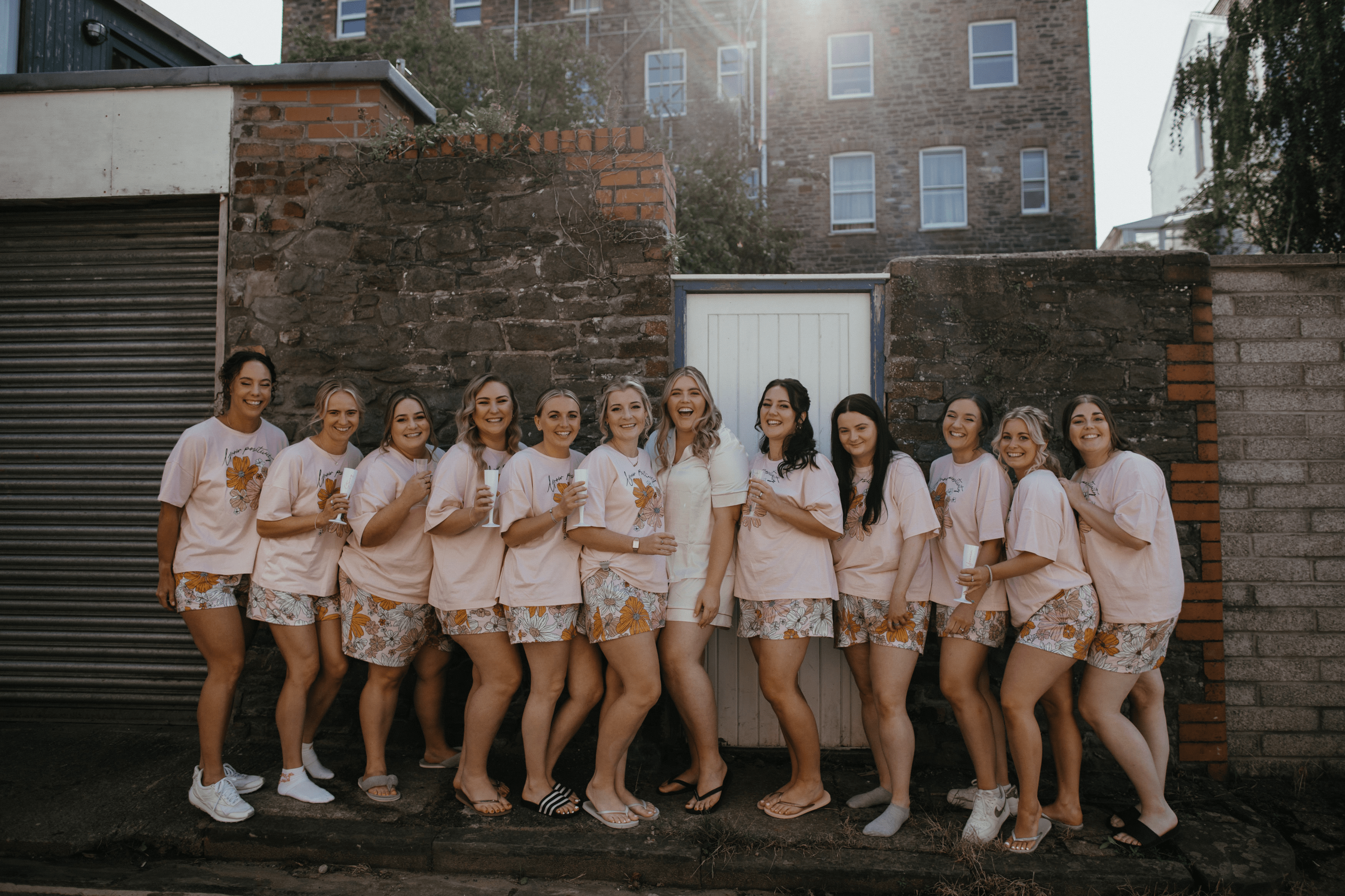 blonde bride and 13 bridesmaids in matching pajamas